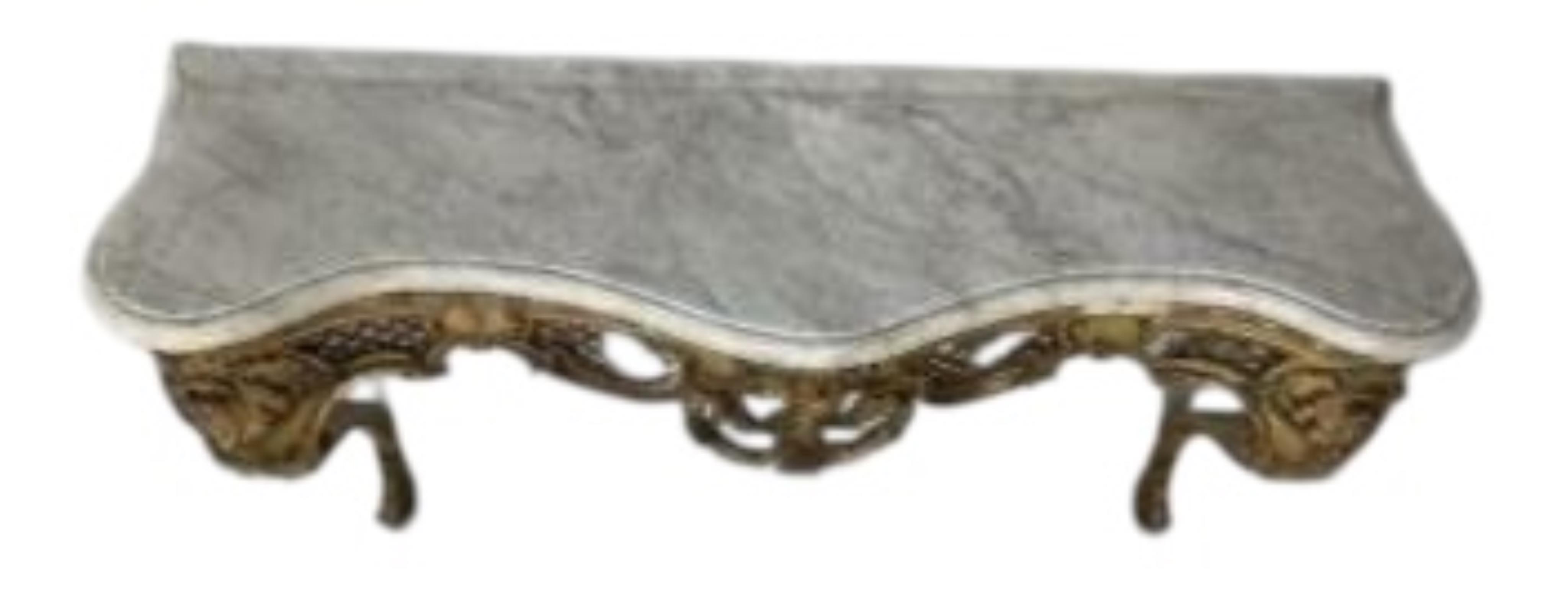 A Victorian carved giltwood and composition marble topped serpentine console table and mirror, width 132cm, height 177cm.